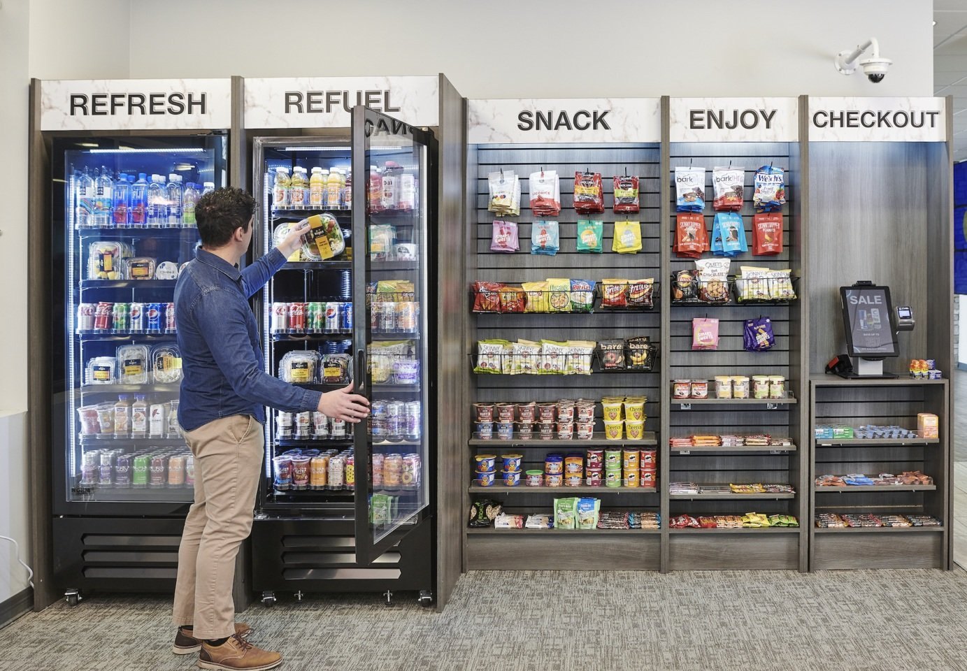 Open market layout with two coolers, snack displays and self-checkout